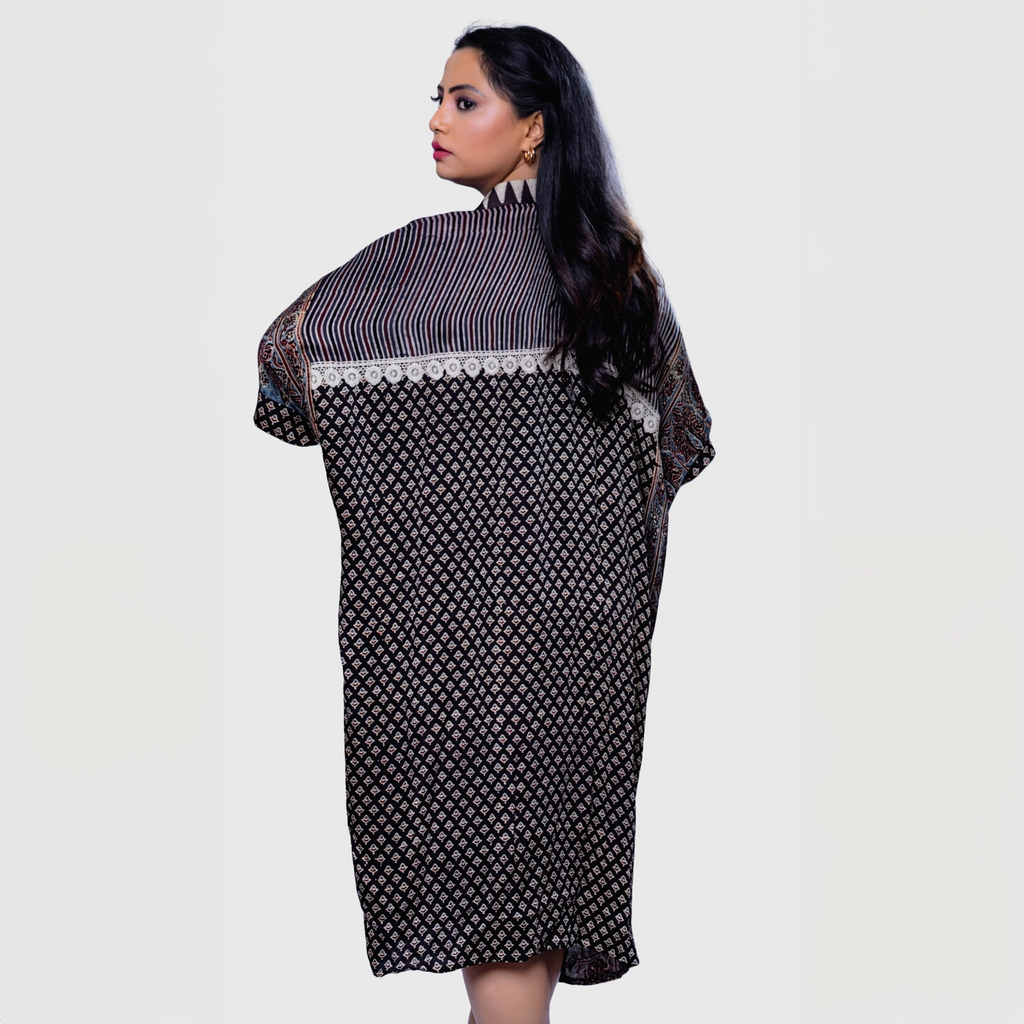 Woman wearing Natasha Mehta ajrakh mosaic cape kaftan with intricate geometric patterns and cape design