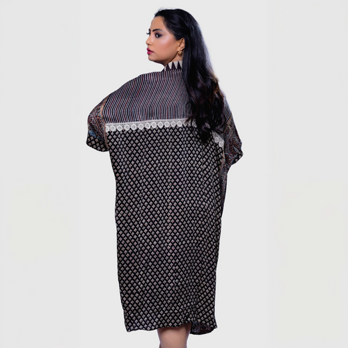 Woman wearing Natasha Mehta ajrakh mosaic cape kaftan with intricate geometric patterns and cape design