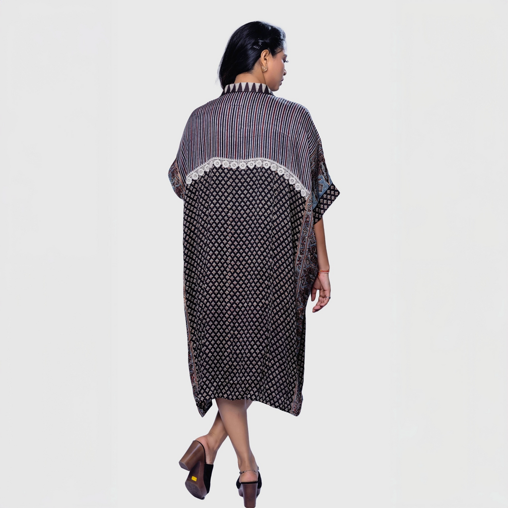 Woman wearing Natasha Mehta ajrakh mosaic cape kaftan with mixed patterns and mid-length design