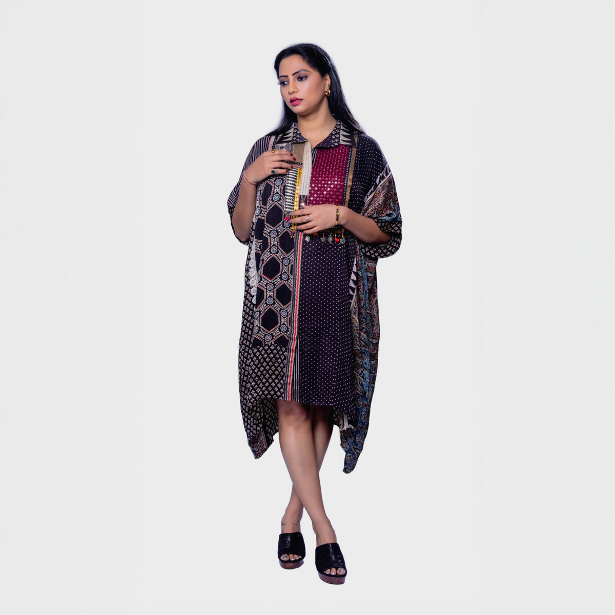 Woman wearing ajrakh mosaic cape kaftan with geometric and floral patterns by Natasha Mehta