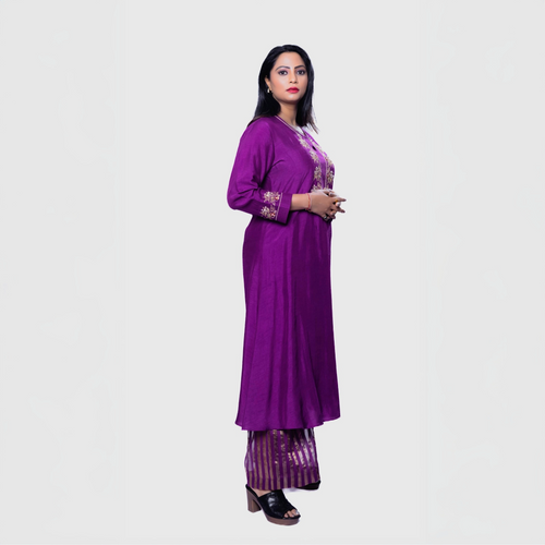Woman wearing purple Amara embroidered kurta set with matching pants and black heels