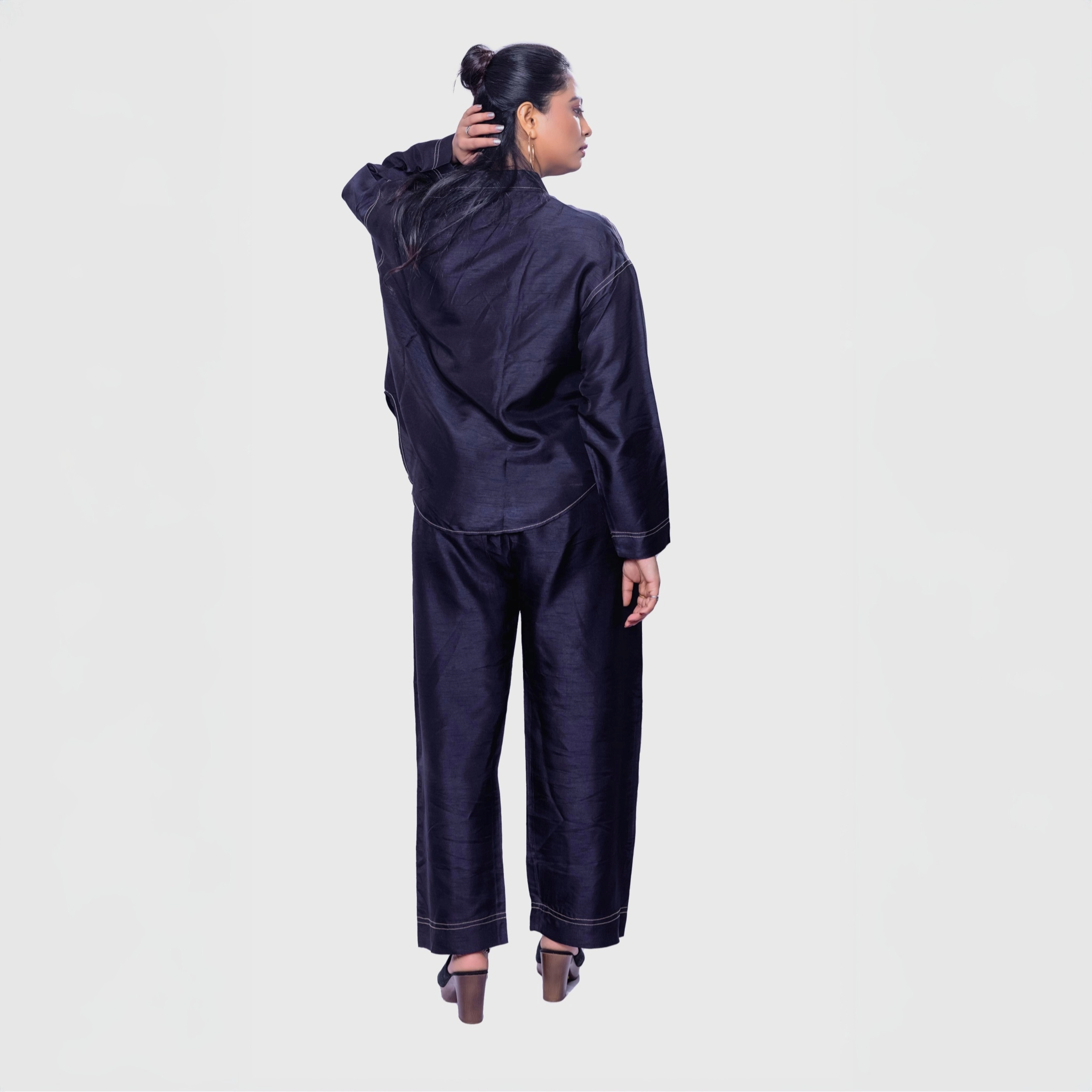 Back view of woman in navy shirt and pants set with heels showcasing handcrafted designer clothing for women by My Store