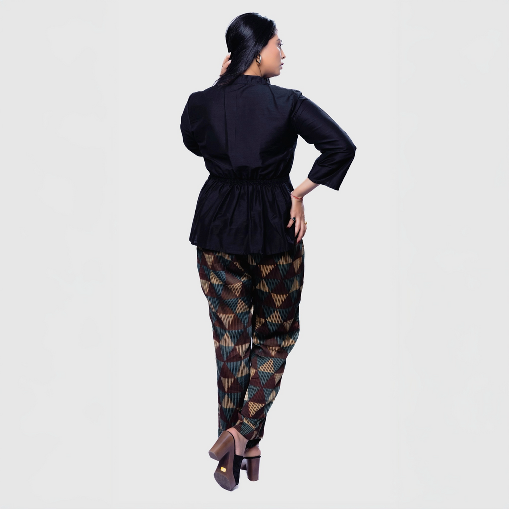 Stylish black collared top and pants set featuring a cinched waist and patterned trousers