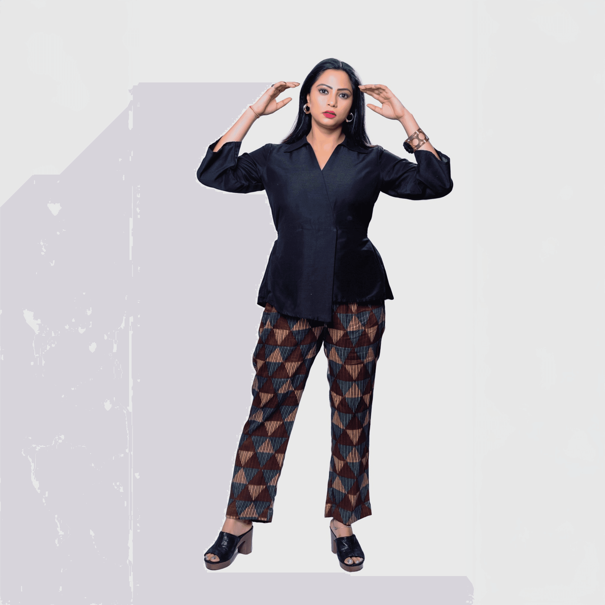 Elegant black collared top and pants set featuring geometric patterned trousers for a stylish look