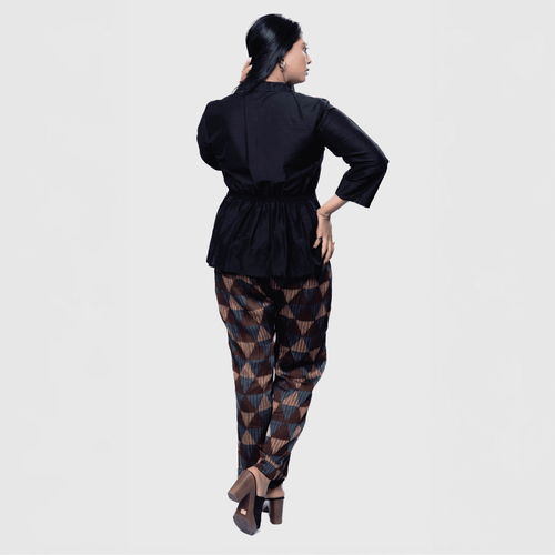 Stylish black collared top and pants set featuring a cinched waist and patterned trousers