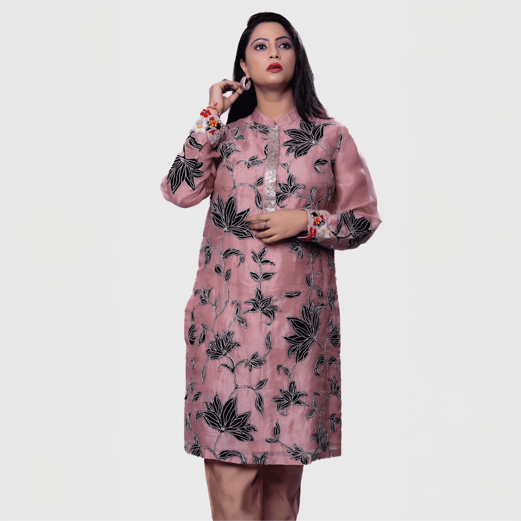 Blush floral embroidered kurta set featuring intricate black leaf patterns and colorful floral accents