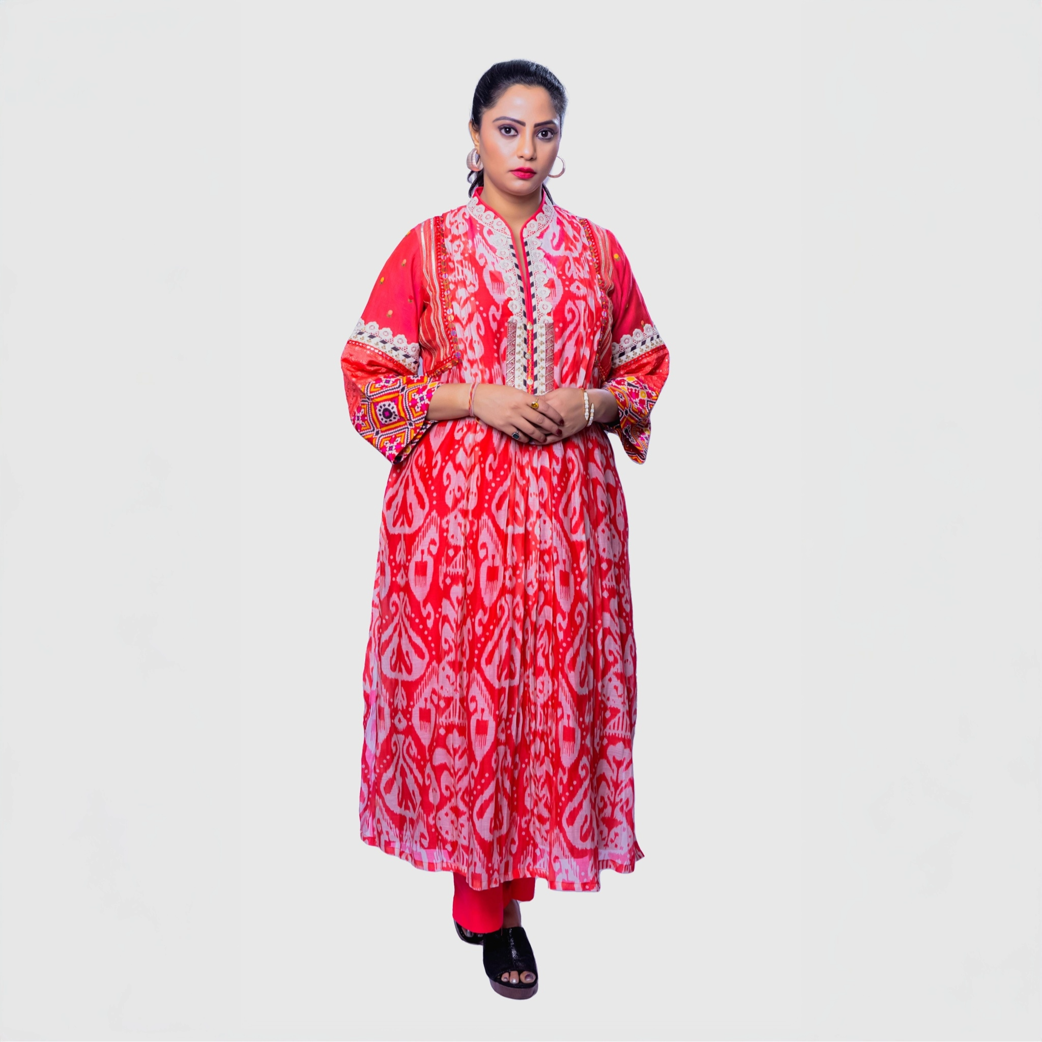Bright red embroidered kurta set for women featuring intricate patterns and bell sleeves, perfect for festive occasions.