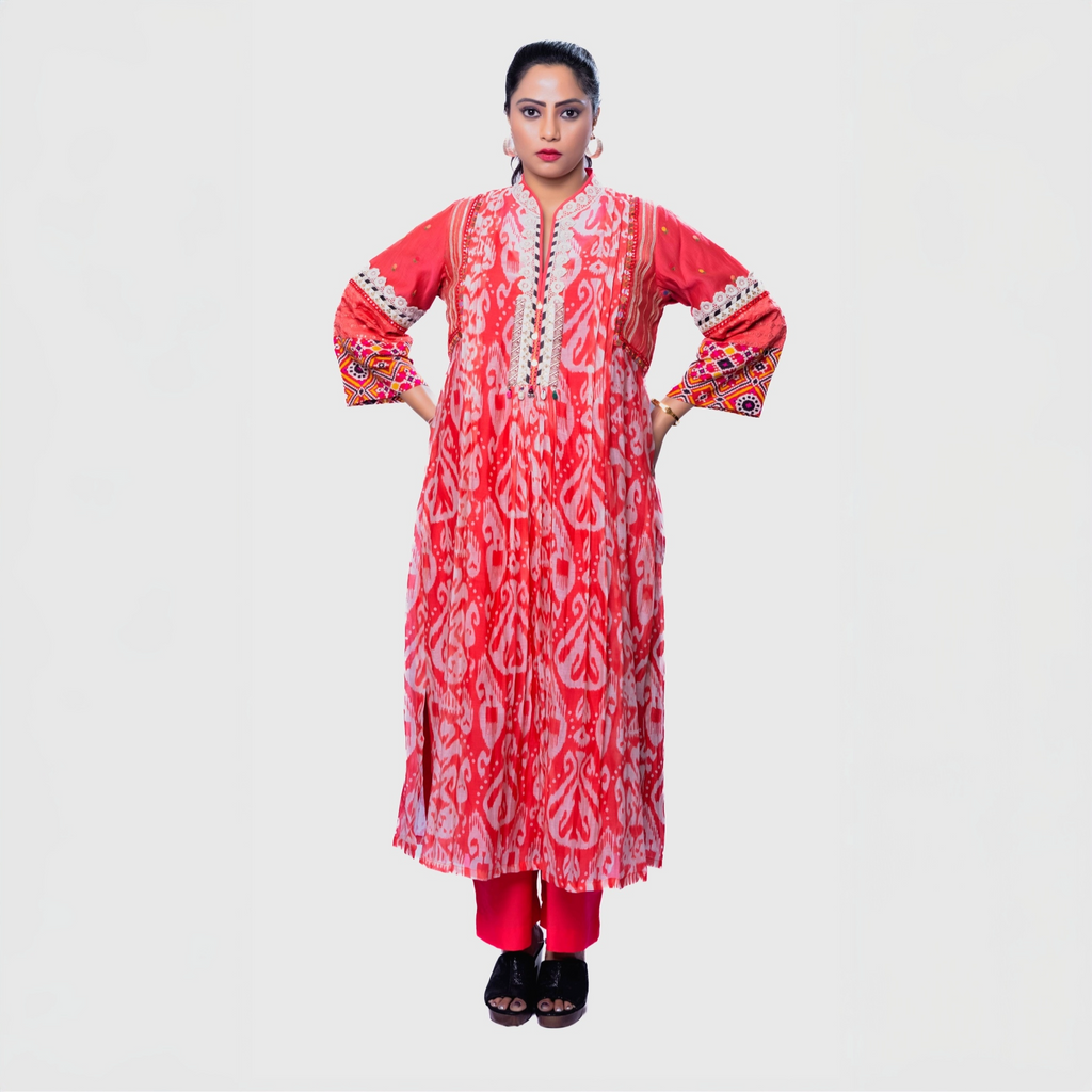 Embroidered kurta set for women in vibrant coral with intricate floral patterns and embellished sleeves, perfect for festive occasions.