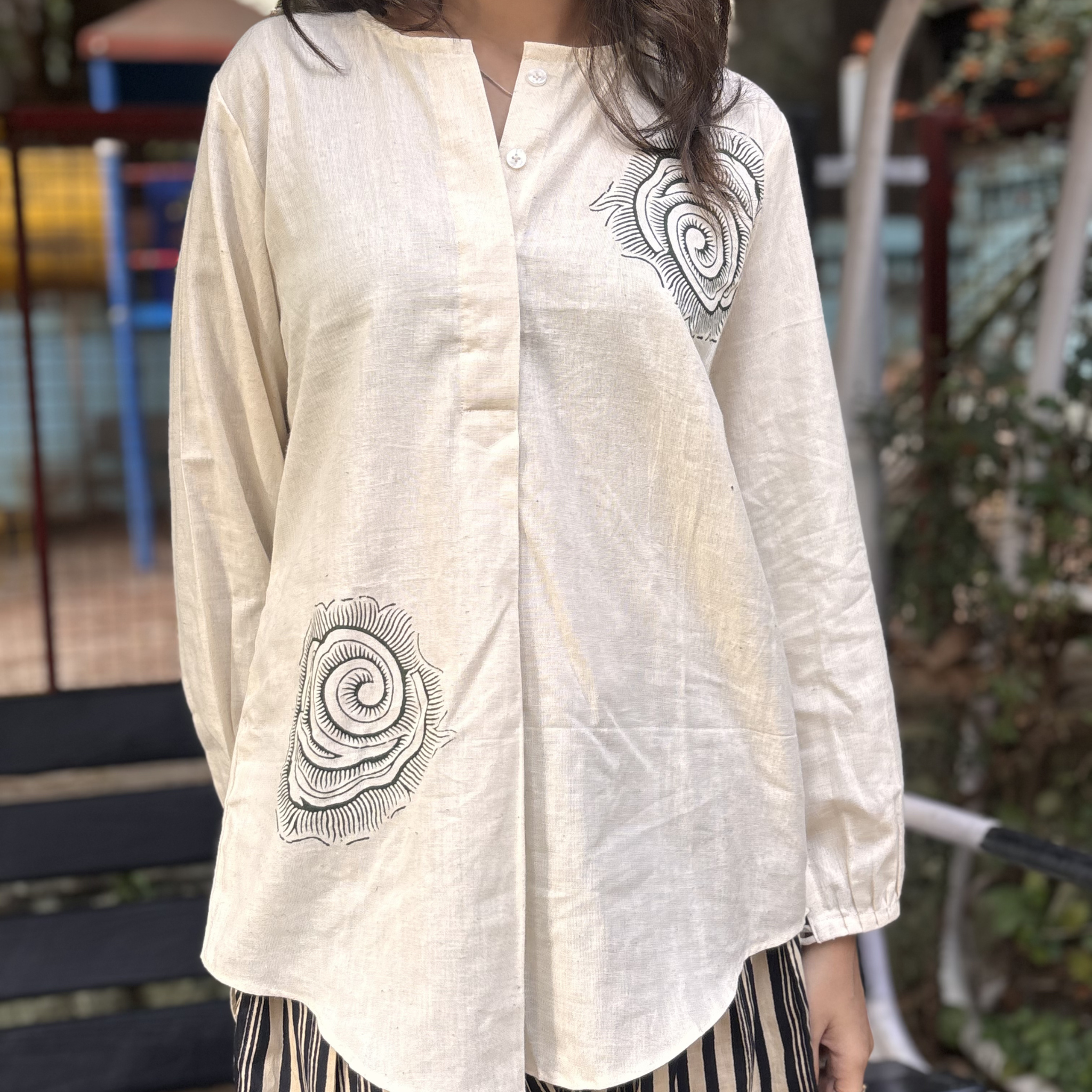 Stylish cream blouse by Natasha Mehta with black spiral embroidery, suitable for casual wear at great sand dune national park