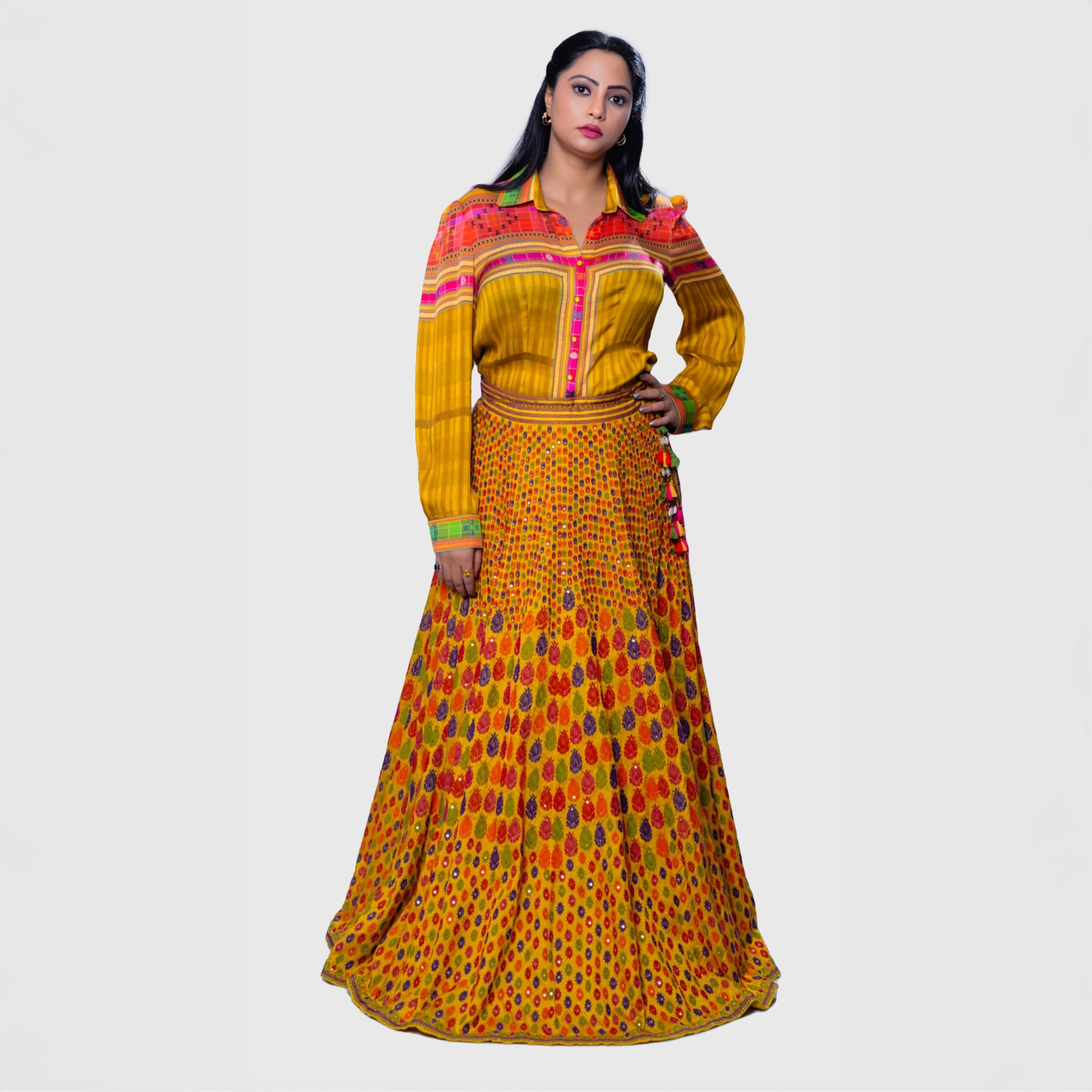 Colorful leheriya ensemble for parties featuring a vibrant shirt and long skirt in yellow and patterns
