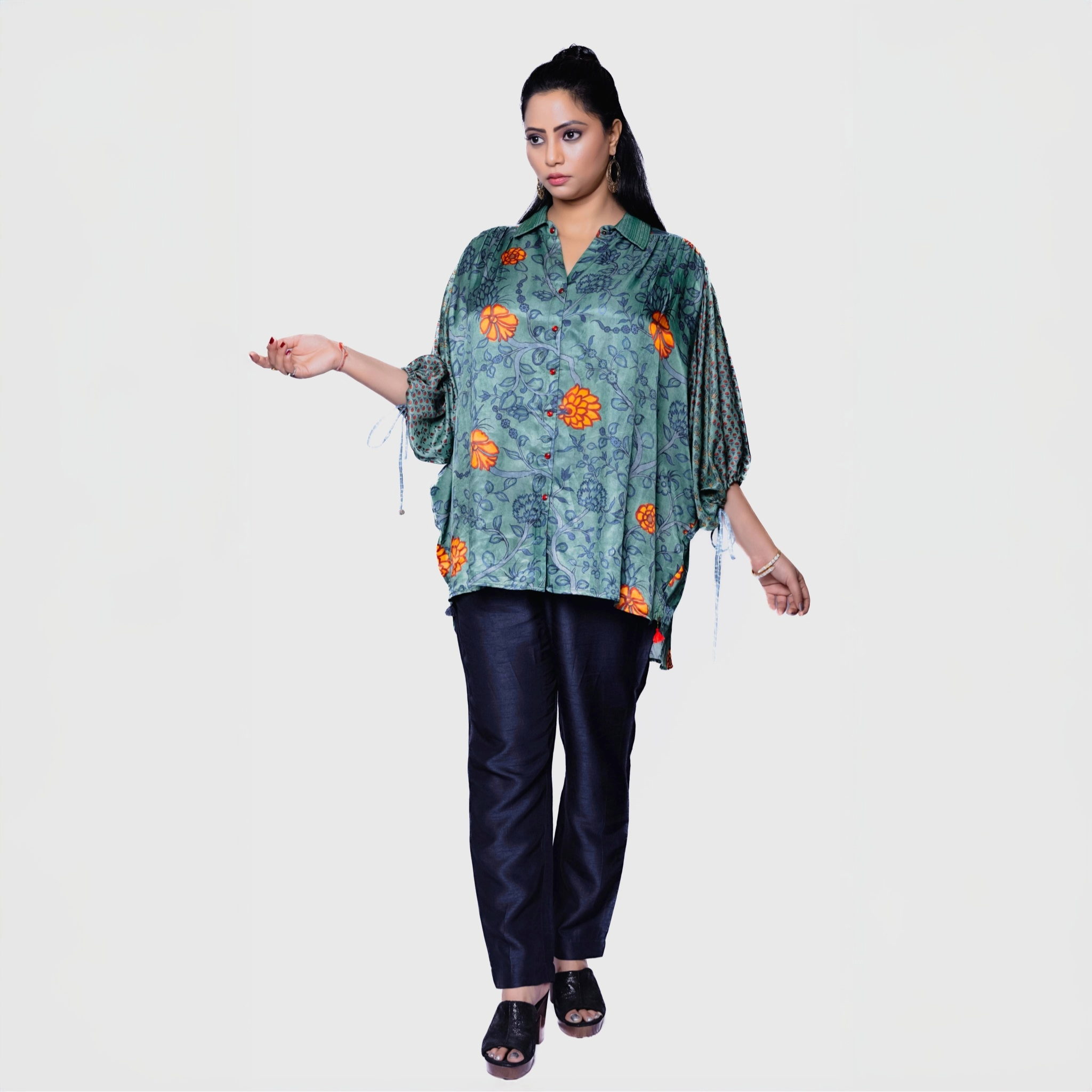 Designer collared kurta for women in green floral print with black pants and open-toe sandals