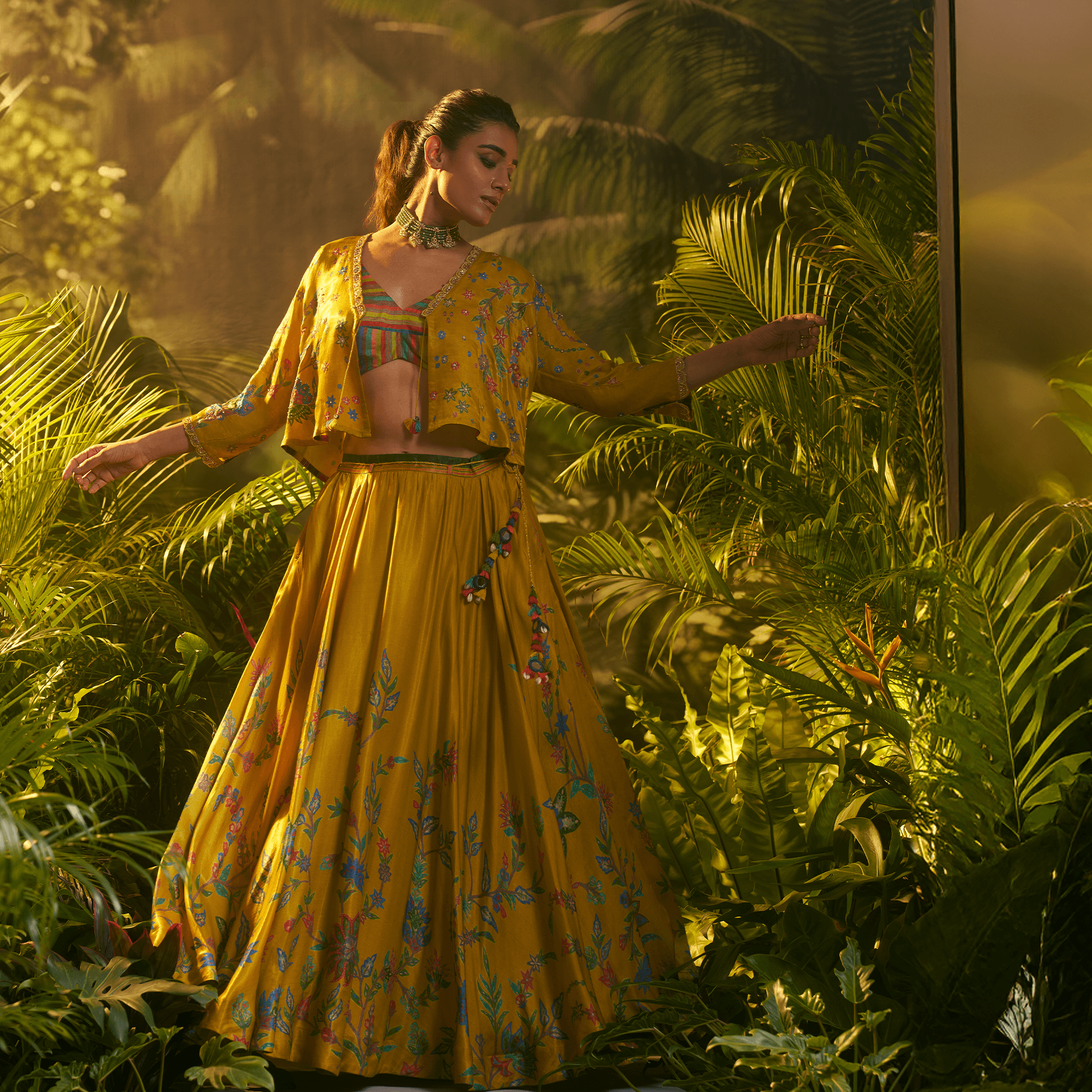 Stunning designer ghaghra choli with jacket in vibrant yellow, adorned with floral patterns for festive occasions