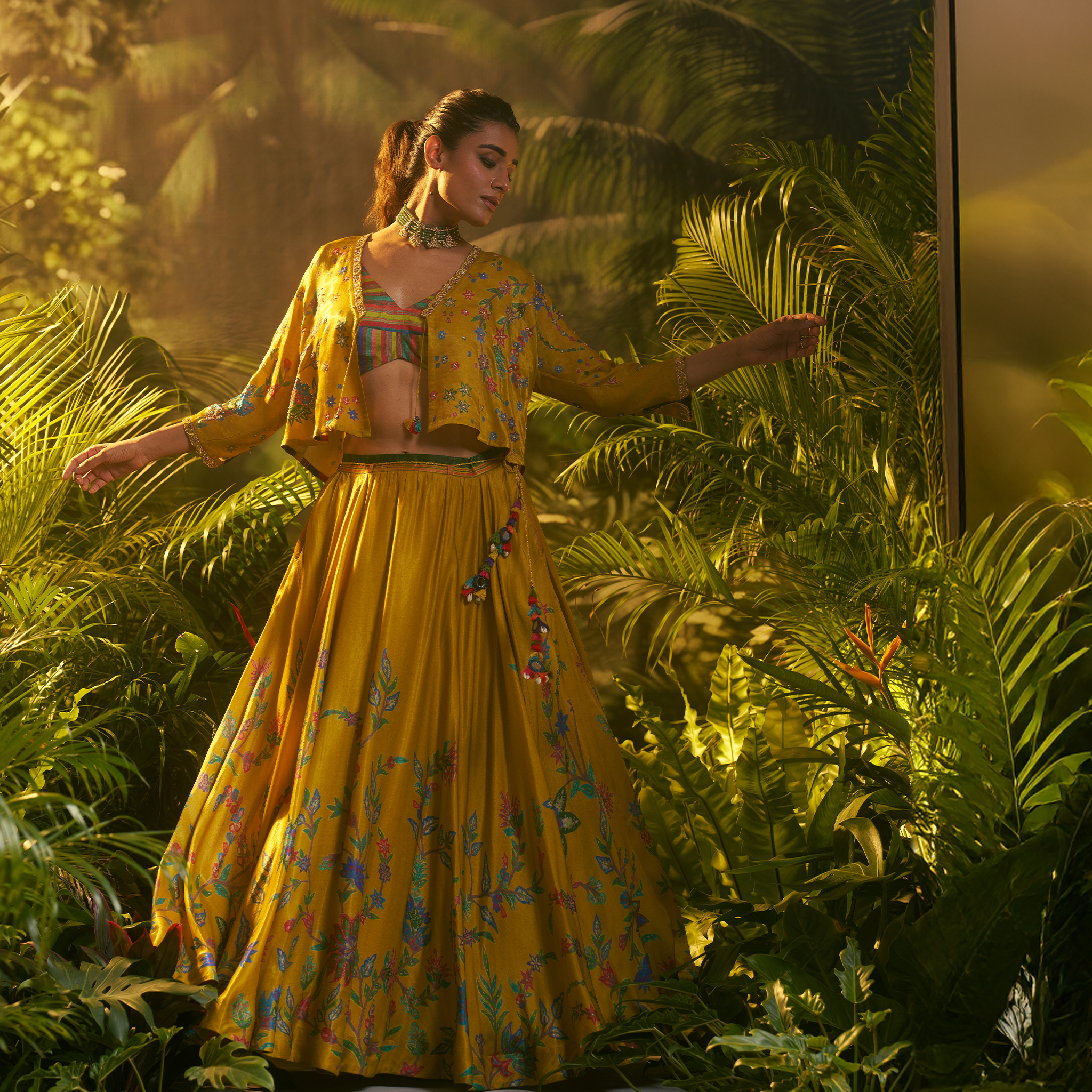 Stunning designer ghaghra choli with jacket in vibrant yellow, adorned with floral patterns for festive occasions