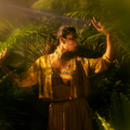 Stunning designer ghaghra choli with jacket in vibrant colors showcased among lush greenery