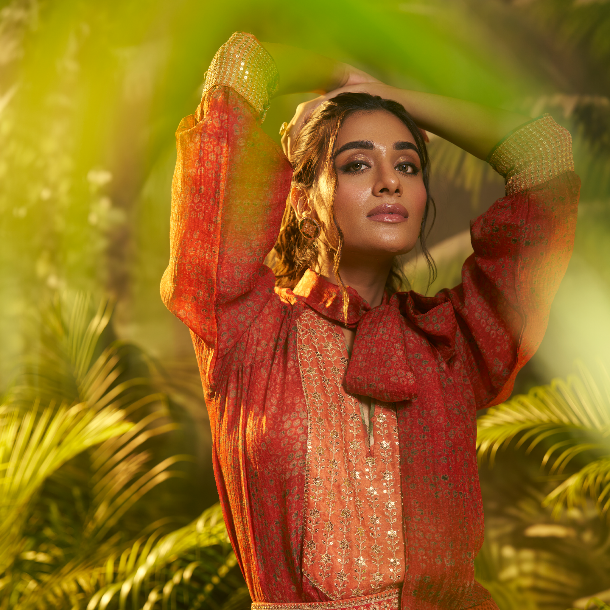 Elegant designer Indian fusion wear Dubai featuring intricate patterns in a vibrant orange hue