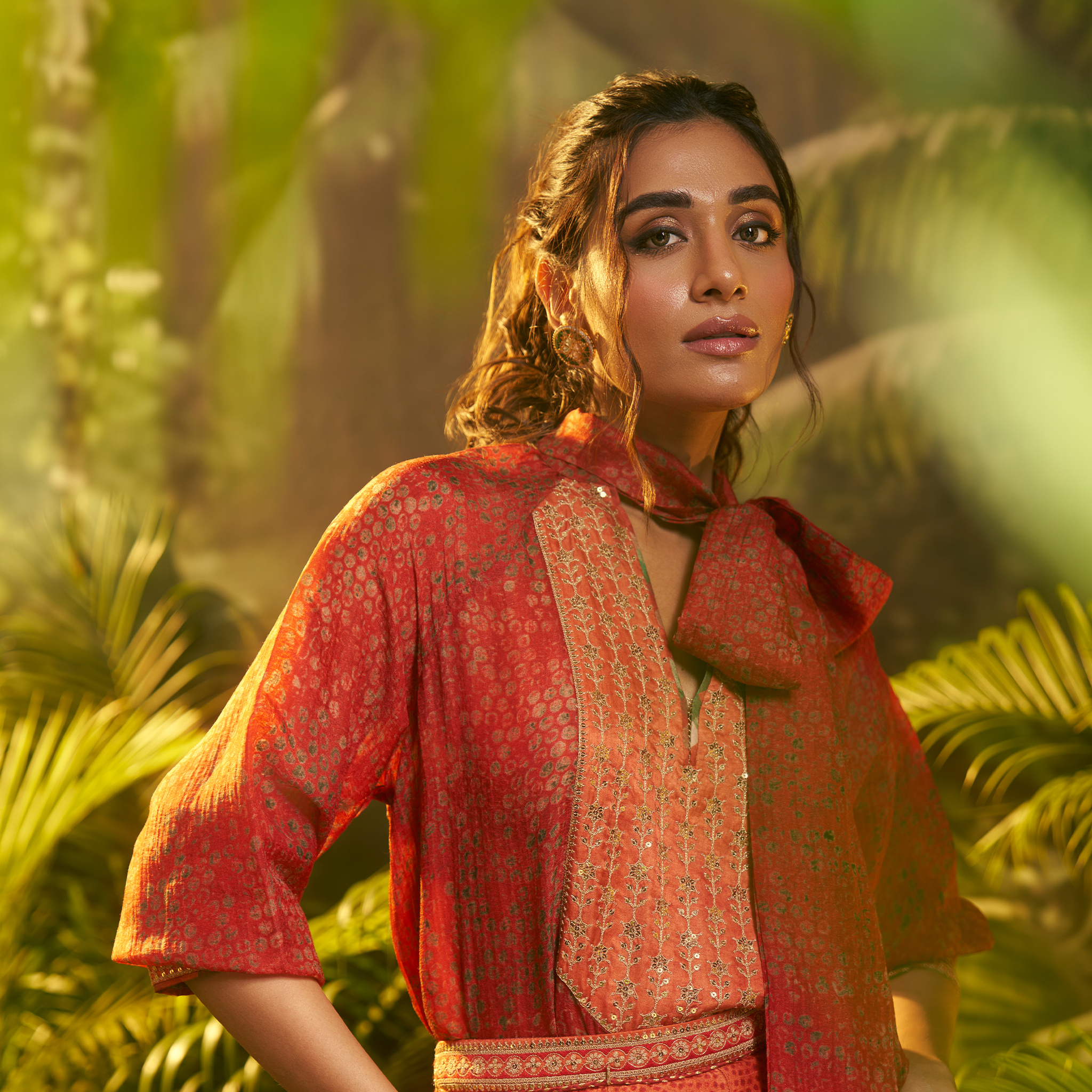 Elegant designer Indian fusion wear Dubai featuring a vibrant red outfit with intricate details