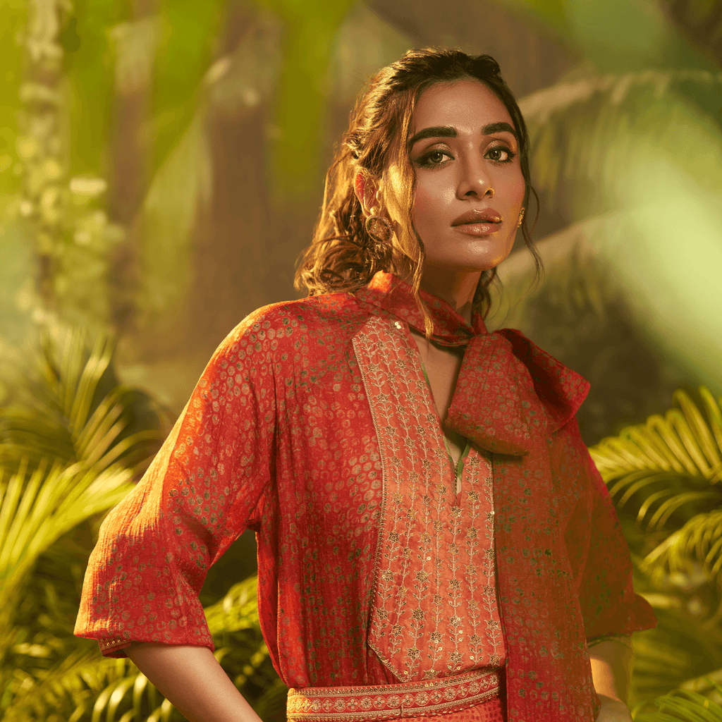 Elegant designer Indian fusion wear Dubai featuring a vibrant red outfit with intricate details