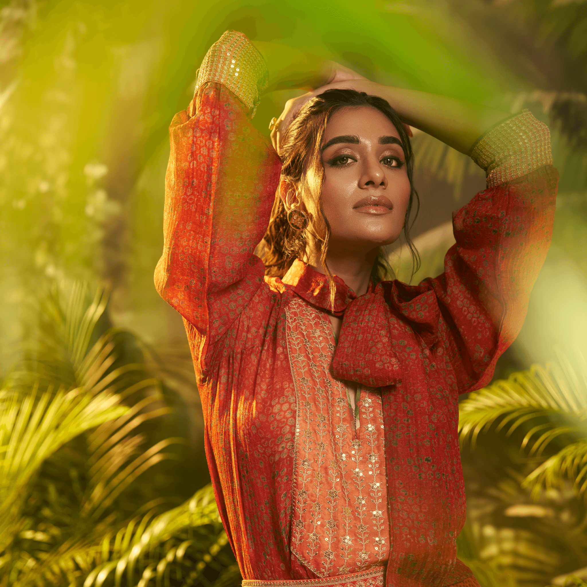 Elegant designer Indian fusion wear Dubai featuring intricate patterns in a vibrant orange hue