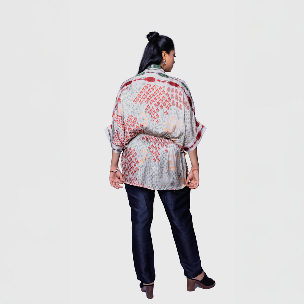 Elegant beige designer kaftan top for women with red and orange floral patterns, ideal for casual outings or Dubai.