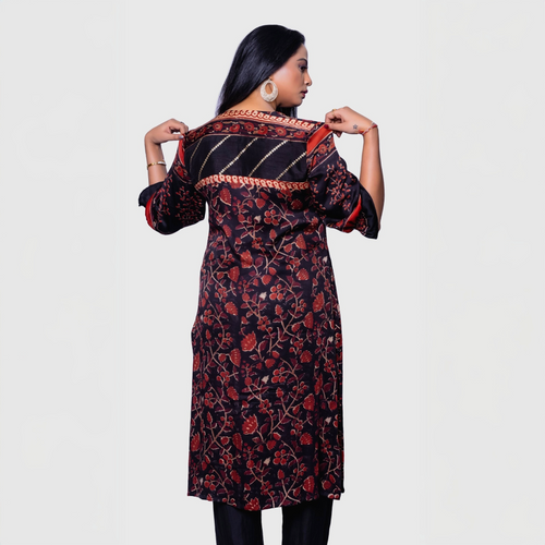 Back view of a woman wearing a designer rust kurta for women with floral and striped patterns