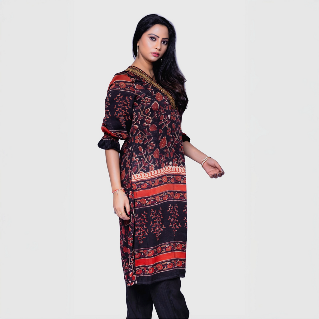 Woman wearing designer rust kurta for women with black and rust floral patterns and long sleeves