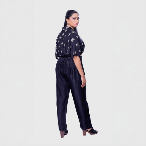 Woman wearing a handcrafted black co-ord outfit with embroidery featuring a black top and pants