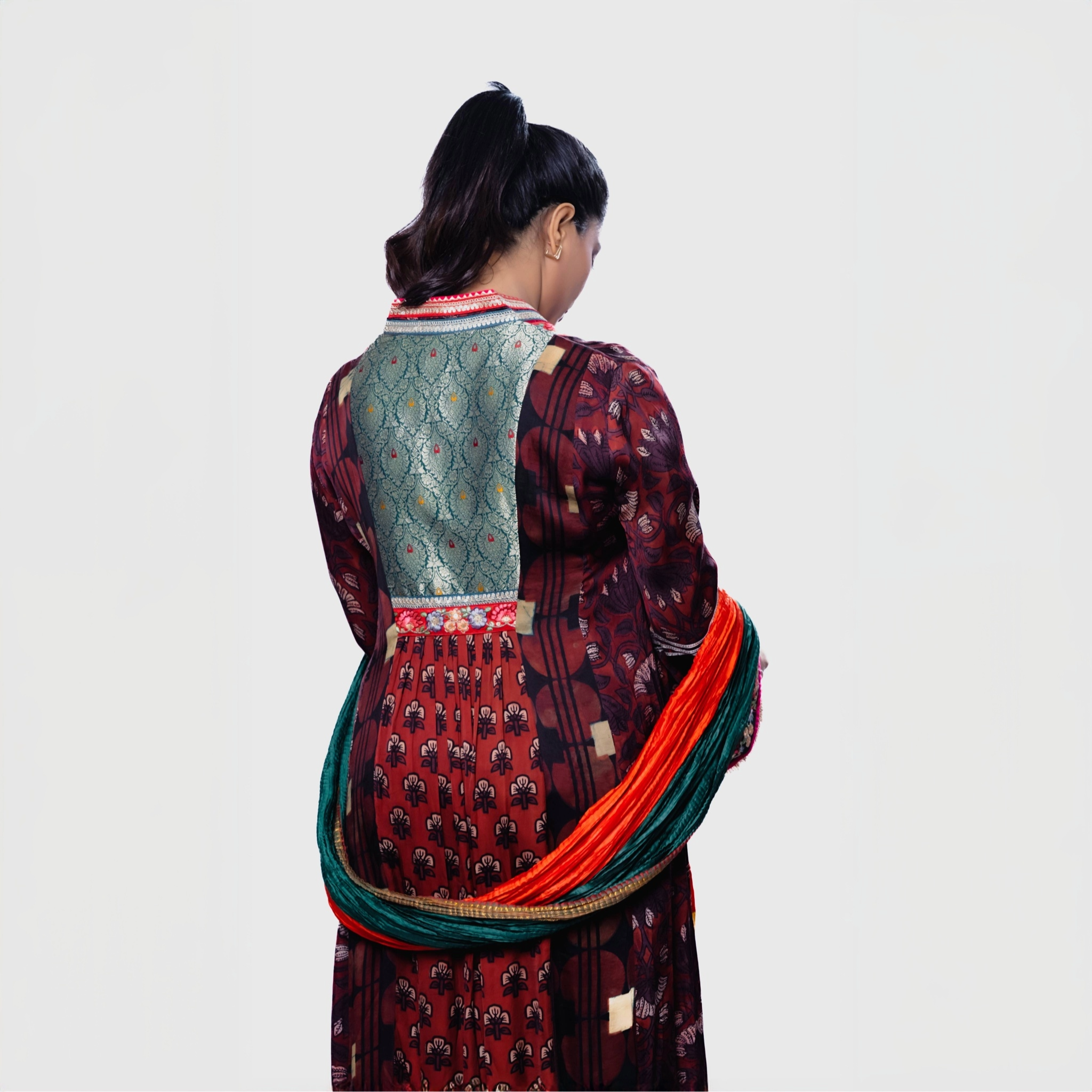 Elegant Salwar and Khameez set featuring a handcrafted phulkari charm set and vibrant colors