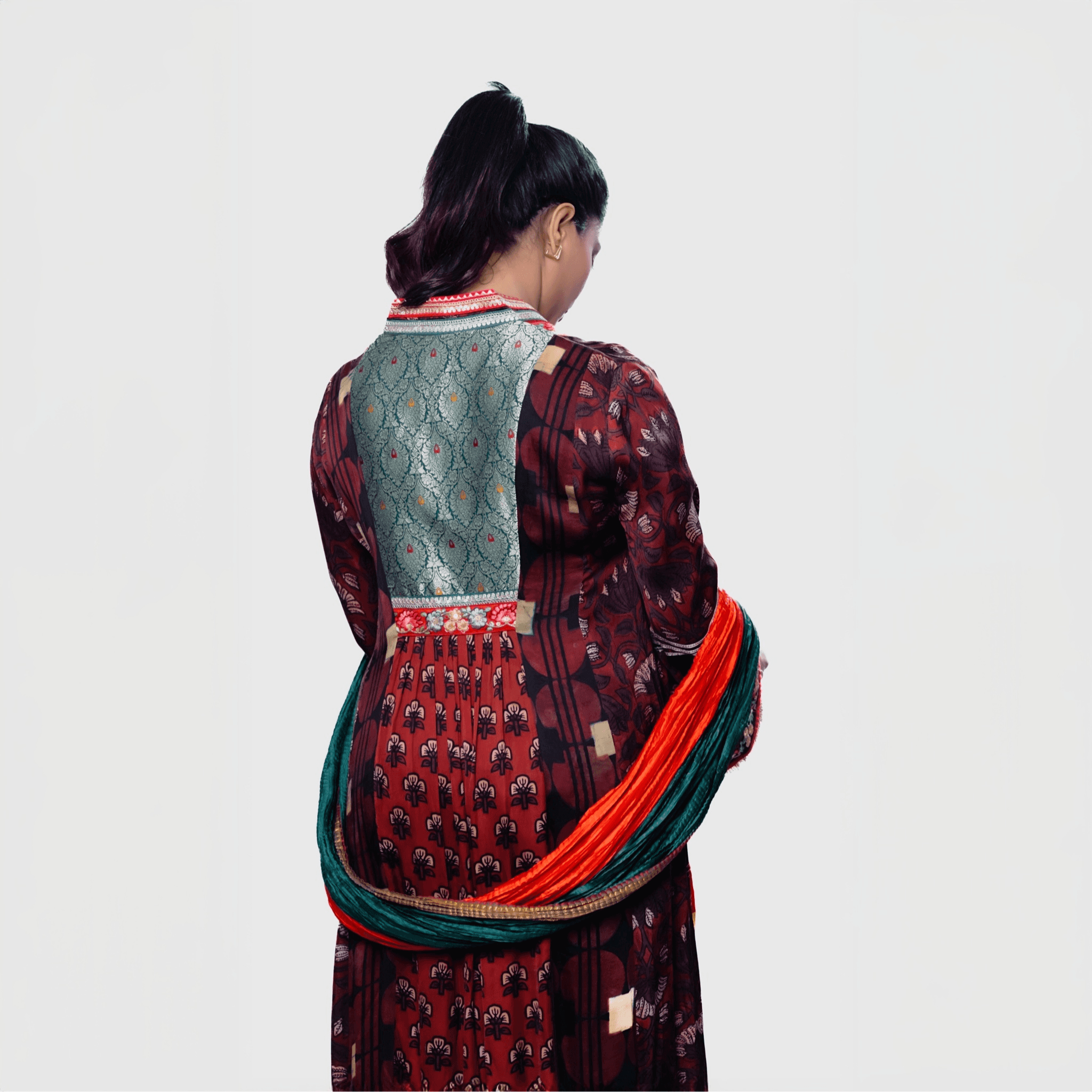 Elegant red and black salwar with intricate patterns, paired with a handcrafted phulkari charm set for festive occasions