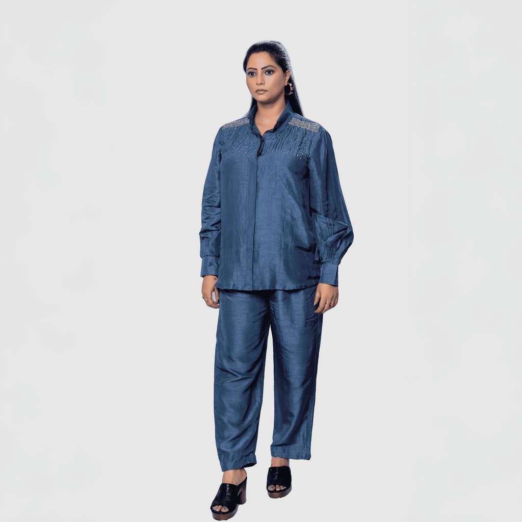 Elegant woman wearing a luxury two-piece party set in navy blue with stylish details and relaxed fit