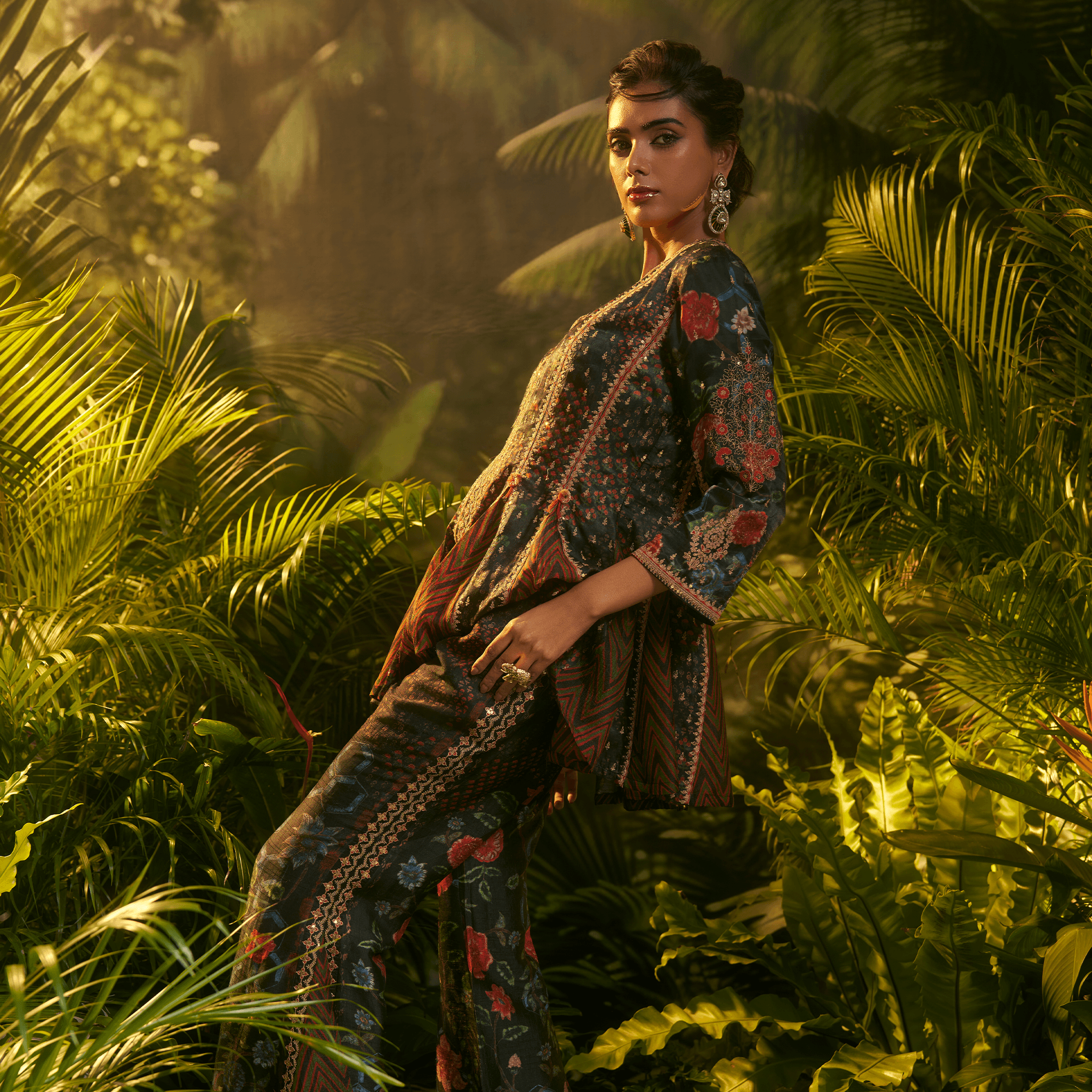 Elegant midnight bloom peplum ensemble with intricate floral patterns and flowing silhouette in a tropical setting