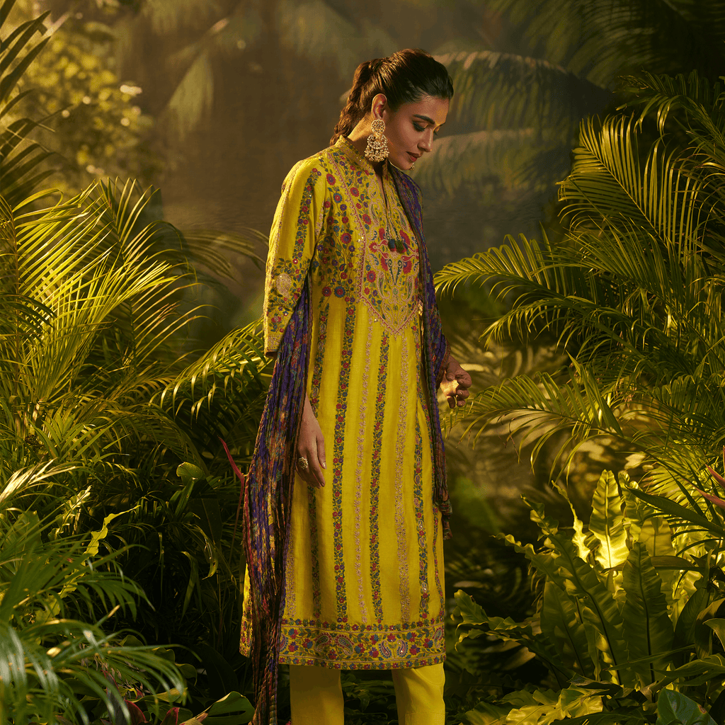 Mustard yellow embroidered kurta set featuring intricate designs and elegant draping for a stylish look