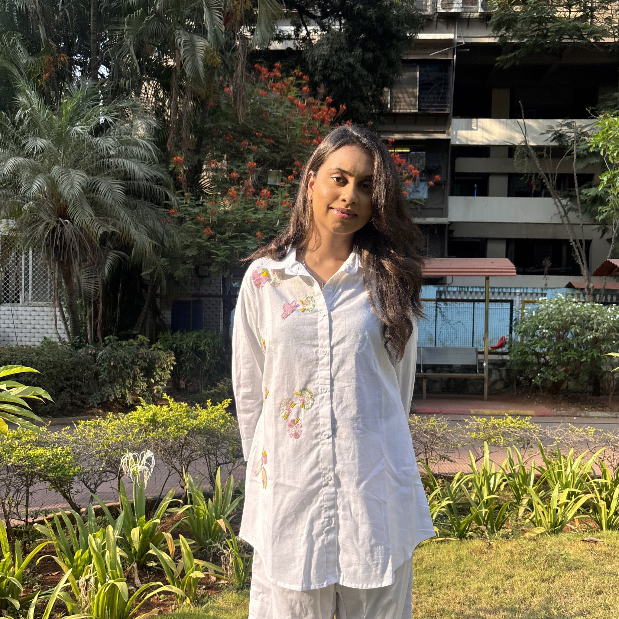 White cotton women's clothing blouse with floral embroidery, perfect for casual outings.
