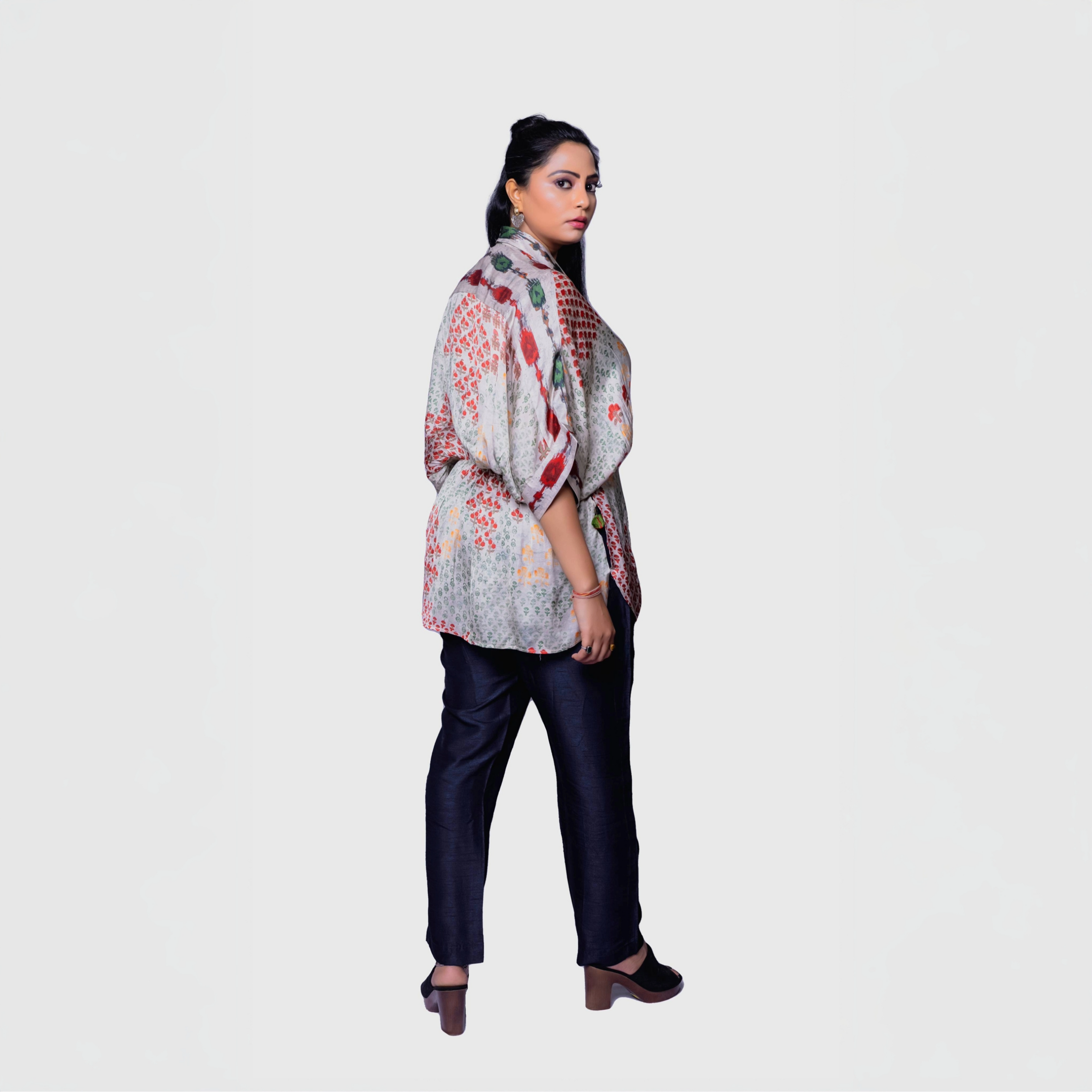 Model wearing floral printed designer kaftan top for women with black trousers and block heels
