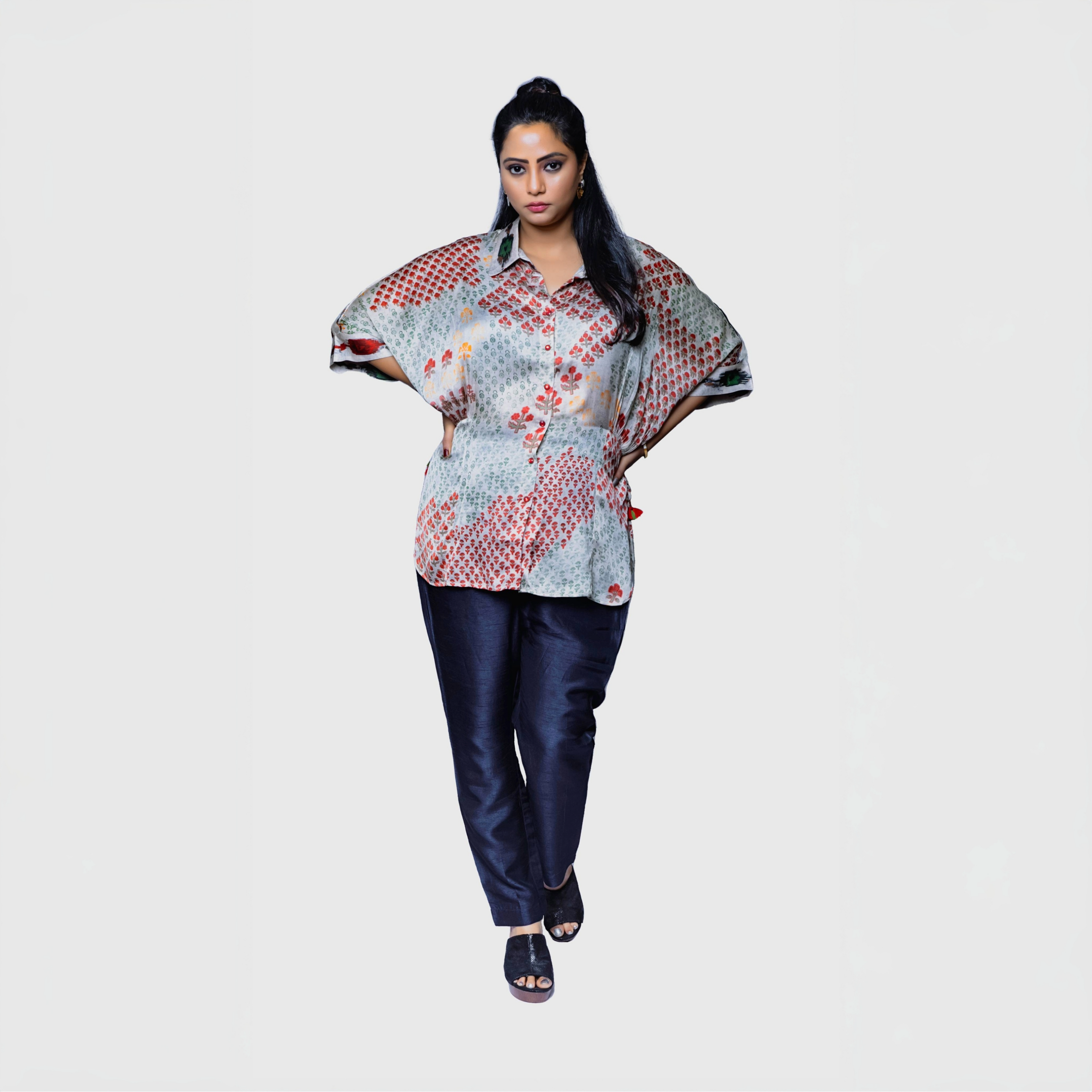 Model wearing patterned designer kaftan top for women paired with navy pants on white background by My Store