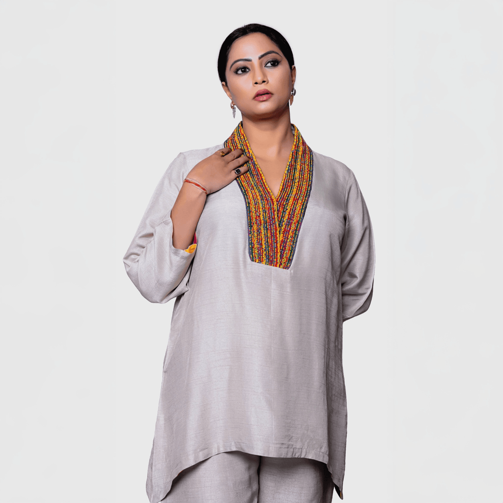 Elegant pearl white kurta set for women featuring vibrant neckline detailing and a comfortable fit