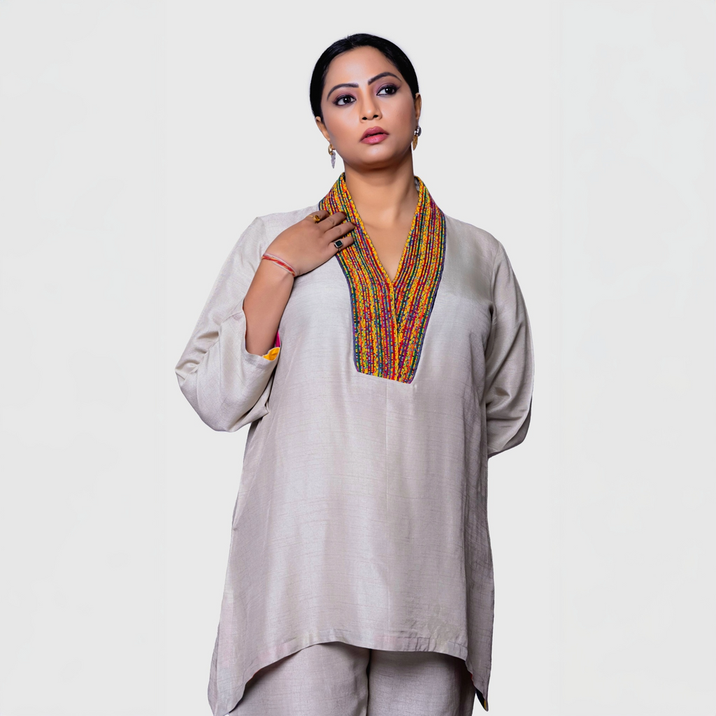 Elegant pearl white kurta set for women featuring vibrant neckline detailing and a comfortable fit