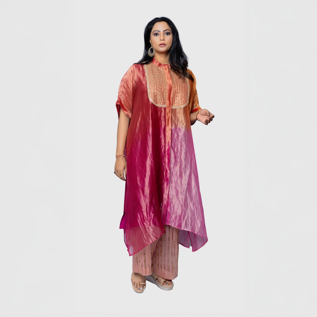 Elegant woman wearing a silk fusion evening gown in vibrant ombre colors with intricate detailing