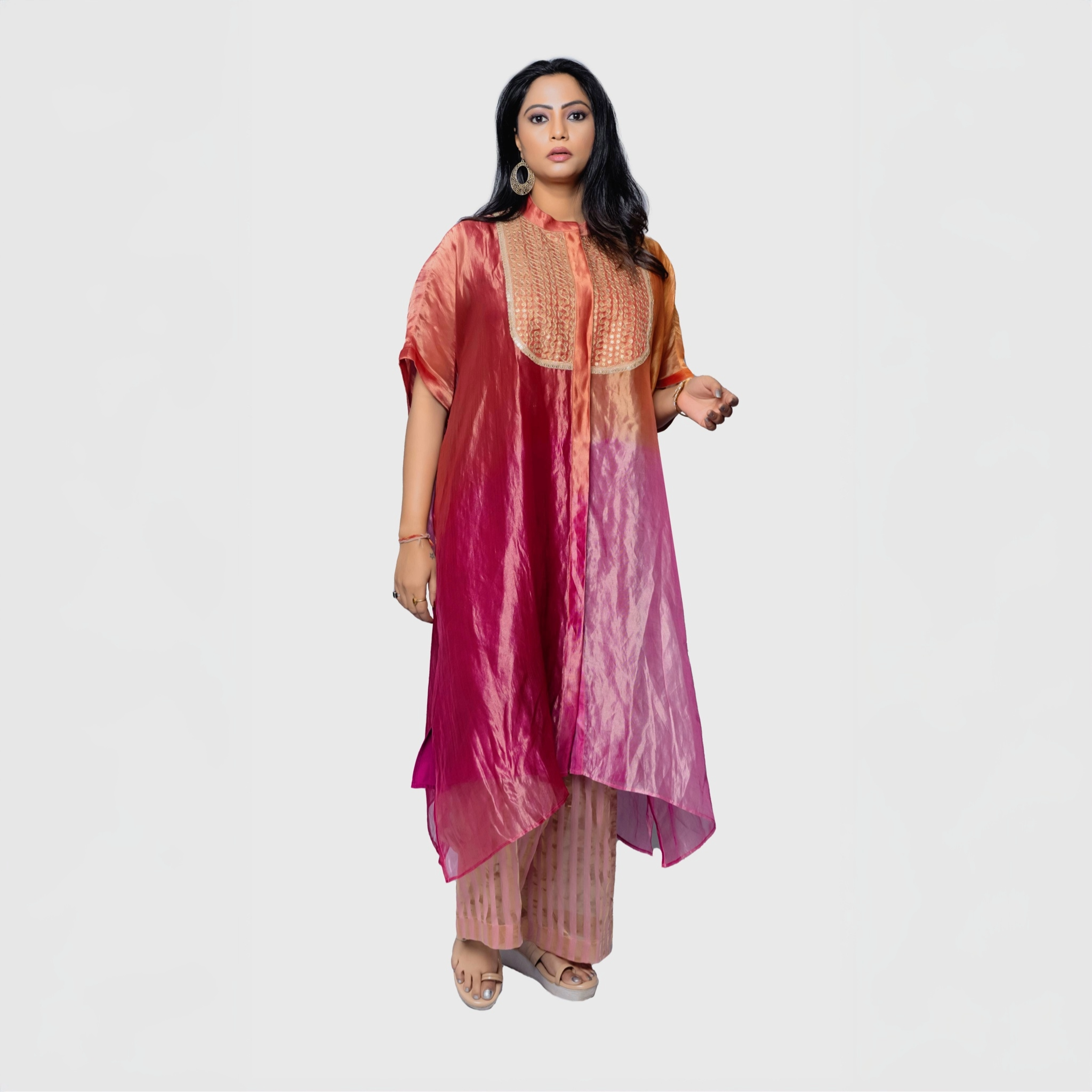 Elegant woman wearing a silk fusion evening gown in vibrant ombre colors with intricate detailing