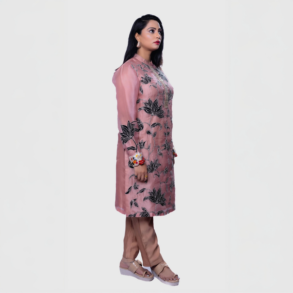 Blush floral embroidered kurta set with intricate black flower designs and matching pants