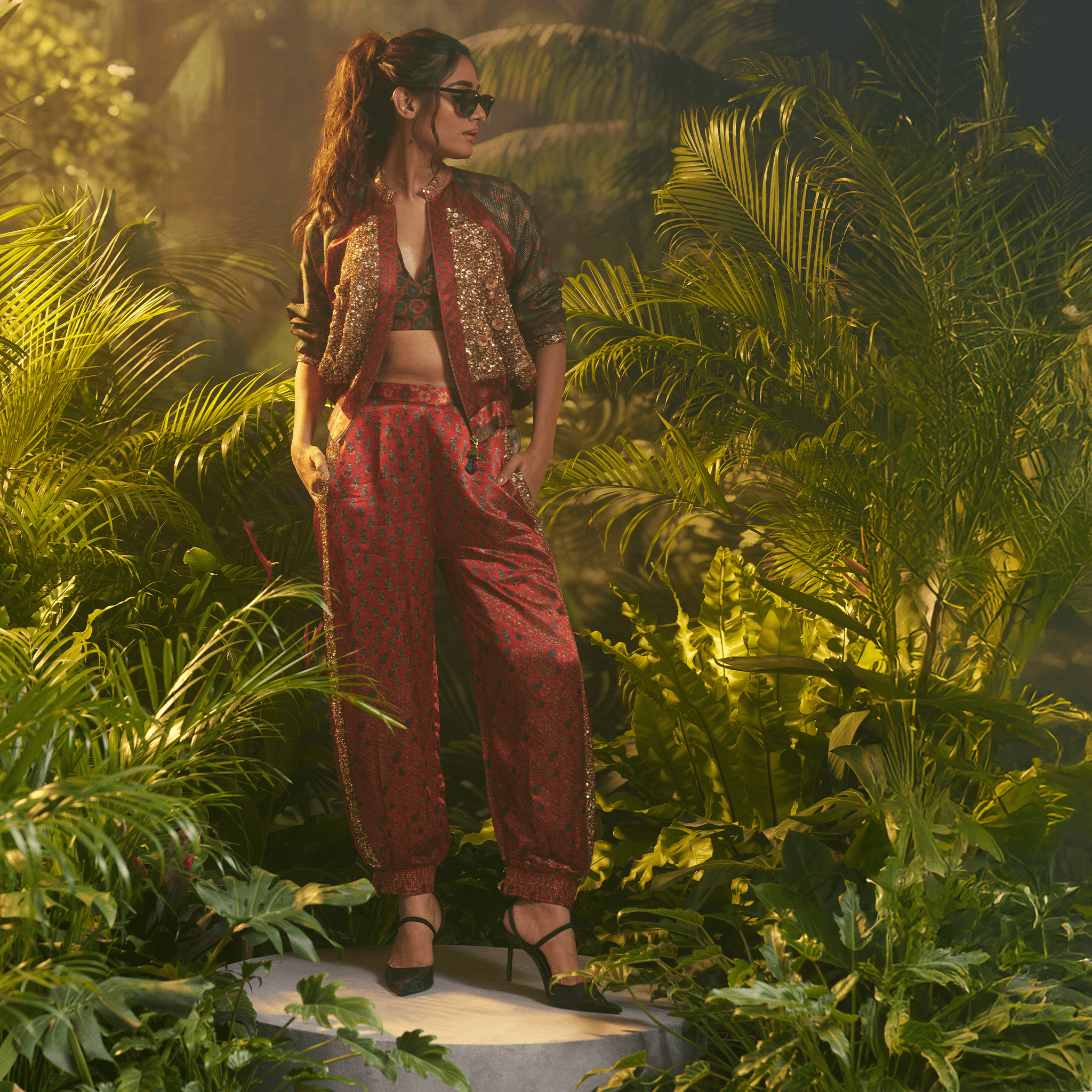 Stylish women's statement bomber jacket India paired with matching pants in a tropical setting